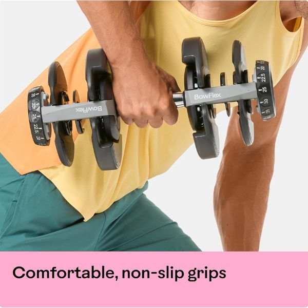 Bowflex SelectTech 552 adjustable dumbbells with dial weight adjustment system in a modern home gym.