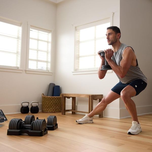 NordicTrack Select-A-Weight adjustable dumbbells with adjustable weight settings in a home gym.