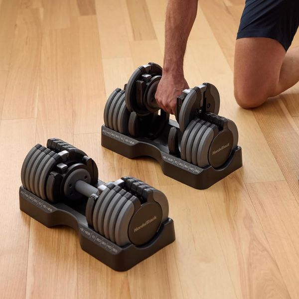 NordicTrack Select-A-Weight adjustable dumbbells with adjustable weight settings in a home gym.