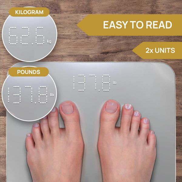 INEVIFIT smart scale with digital display measuring body weight and body fat percentage in a bathroom setting.