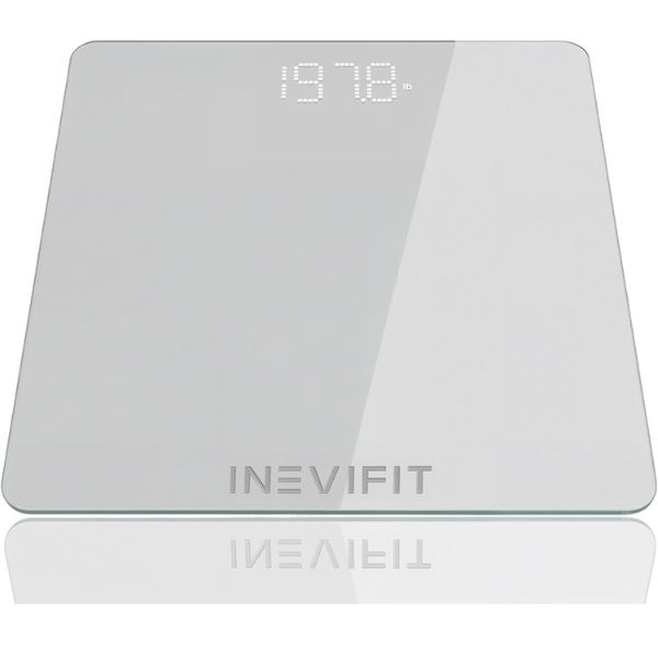 INEVIFIT smart scale with digital display measuring body weight and body fat percentage in a bathroom setting.
